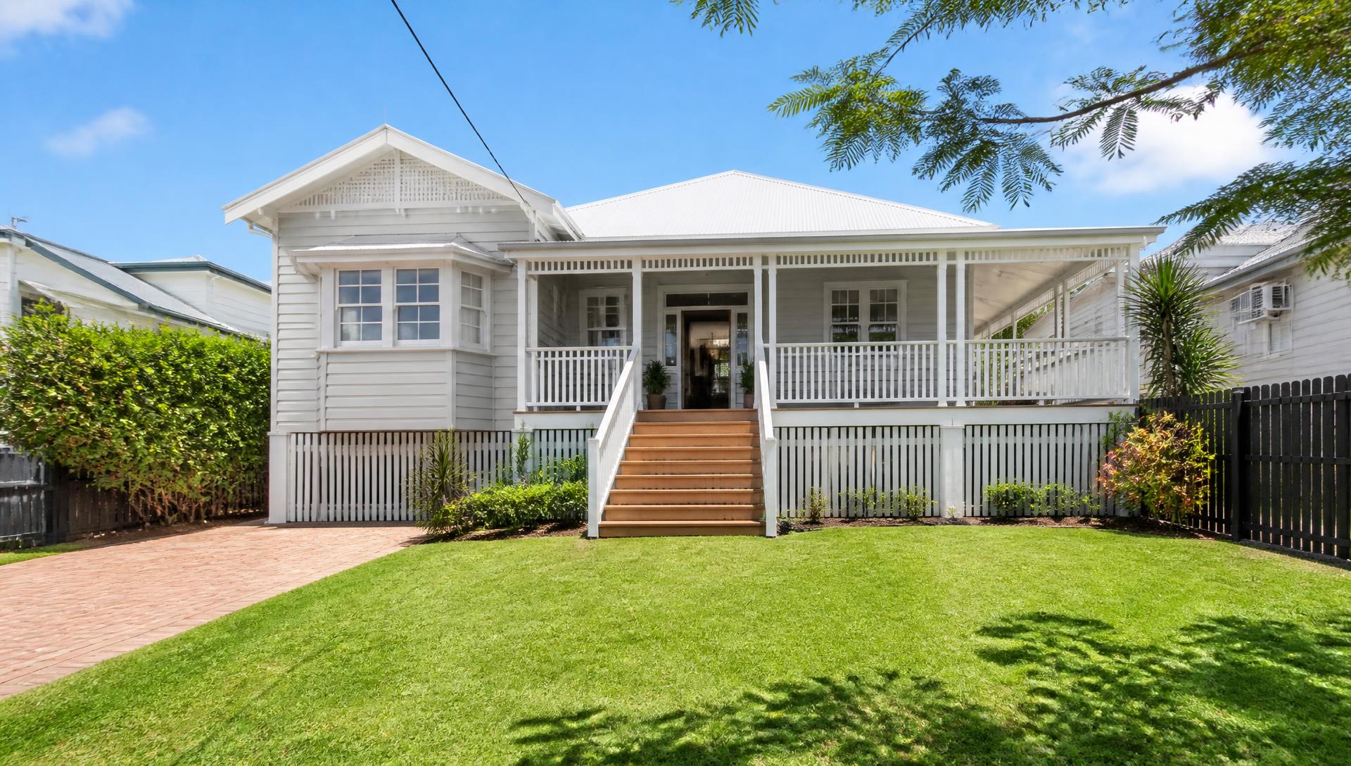 Freshly cleaned Queenslander home exterior with mowed lawn in Brisbane